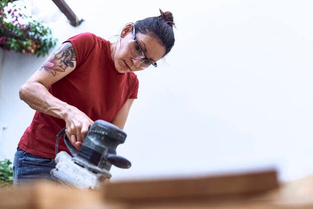 Creative Highlights Symbolfotos Young woman polishing a wooden plank with a power sander Madrid, Community of Madrid, Spain CR_NNSU200909-497259-01 ,model released, Symbolfoto