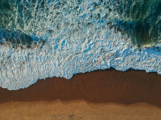 Sand beach aerial, top view of a beautiful sandy beach aerial shot Ericeira, Lisboa, Portugal CR_NUVA200908C-481237-01