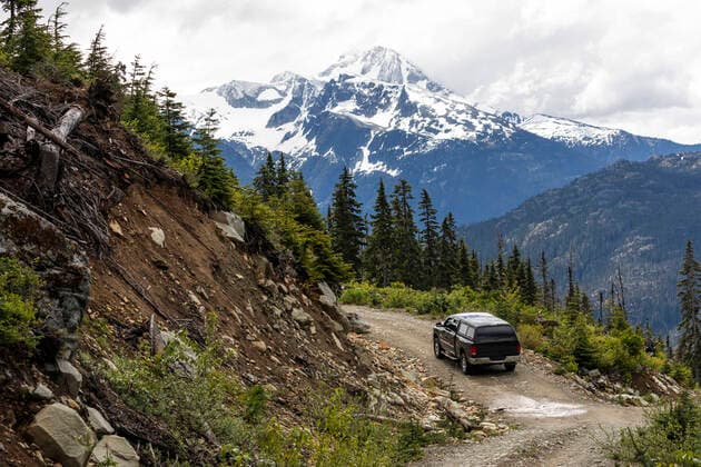 Car driving along countryside road in mountains Canada, British Columbia, Pemberton CR_PSFZ200913C-471350-01