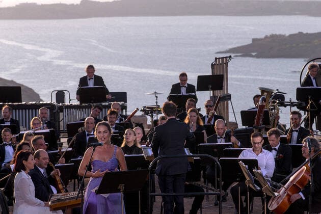 (200917) -- ATHENS, Sept. 17, 2020 -- Musicians perform a musical in front of the ruins of the Temple of Poseidon at cape Sounion, some 70 km southeast of Athens, Greece, on Sept. 17, 2020. On the occasion of the 70th anniversary of the establishment of the Greek National Tourism Organization (GNTO) and the 71st anniversary of the founding of the People s Republic of China and the Mid-Autumn festival, a musical entitled As long as there shall be Achaeans -- Variations on a Sunbeam was staged on Thursday in front of the ruins of the emblematic 2,500-year-old Temple of Poseidon, the god of the sea in Greek mythology. ) GREECE-CAPE SOUNION-MUSICAL-SINO-GREEK FRIENDSHIP MariosxLolos 