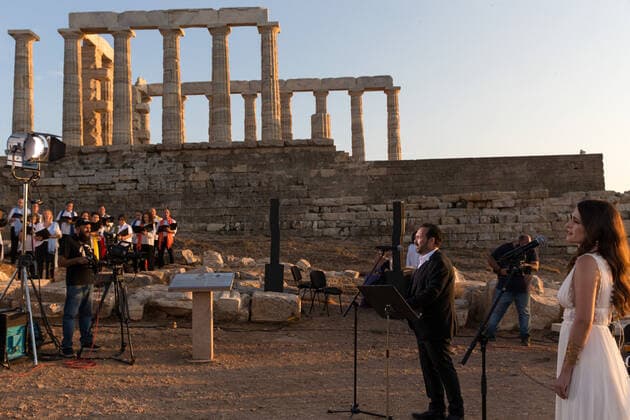(200917) -- ATHENS, Sept. 17, 2020 -- Singers perform a musical in front of the ruins of the Temple of Poseidon at cape Sounion, some 70 km southeast of Athens, Greece, on Sept. 17, 2020. On the occasion of the 70th anniversary of the establishment of the Greek National Tourism Organization (GNTO) and the 71st anniversary of the founding of the People s Republic of China and the Mid-Autumn festival, a musical entitled As long as there shall be Achaeans -- Variations on a Sunbeam was staged on Thursday in front of the ruins of the emblematic 2,500-year-old Temple of Poseidon, the god of the sea in Greek mythology. ) GREECE-CAPE SOUNION-MUSICAL-SINO-GREEK FRIENDSHIP MariosxLolos 