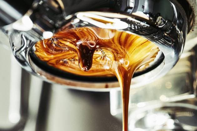 Close up espresso dripping from stainless steel portafilter  Copyright: NormanxPosselt fStopImages1940029