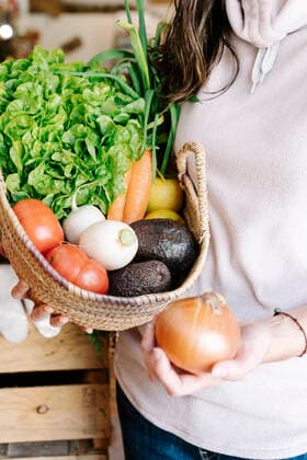 Close-up of vegetable basket held by female customer at store model released Symbolfoto property released RDGF00062