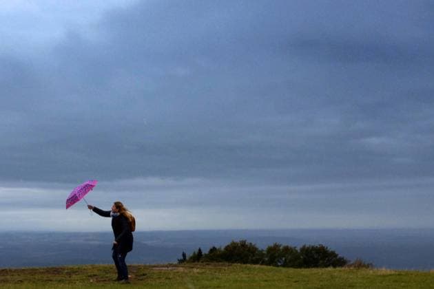 September 28, 2020, Kozakov, Czech Republic: A Woman with umbrella stand on the viewing terrace and watch from the Kozakov (100 kilometers north from Prague) in the Czech Republic. Weather forecasters reported, will rain, windy in Czech Republic and the air temperature will drop, as local media reported. Kozakov Czech Republic - ZUMAr156 20200928_zap_r156_002 Copyright: xSlavekxRutax