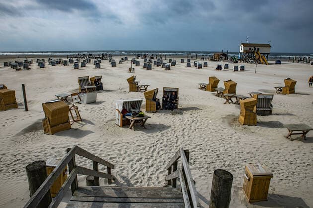 Despite windy autumn weather, many people are on the beach of St Peter Ording to enjoy the natural spectacle on the North Sea