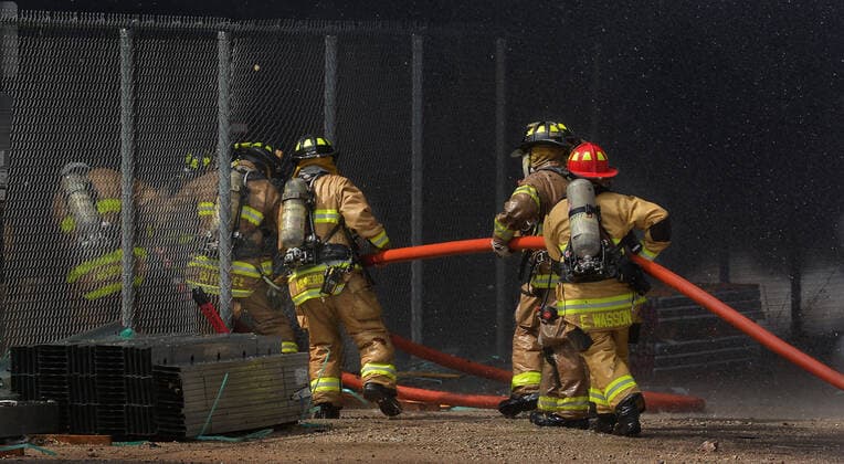 September 29, 2020, Albuquerque, NM, USA: AFR firefighters cut a-way a section of fencing and head into the fire at the Friedman Recycling plant. Tuesday, Sept. 29, 2020. Albuquerque USA - ZUMAab1_ 20200929_zaf_ab1_004 Copyright: xJimxThompsonx