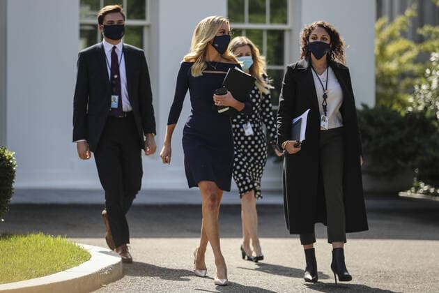White House press secretary Kayleigh McEnany, center, walks prior to a TV interview with Fox outside the West Wing of the White House on Friday, October 2, 2020 in Washington, DC. President Donald Trump and First Lady Melania Trump have tested positive for coronavirus (COVID-19).  WAX20201002292 OLIVERxCONTRERAS