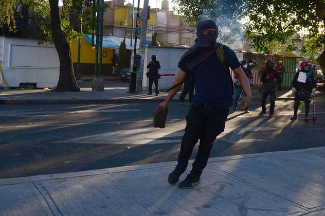 Mexico:52nd Anniversary of Massacre of Tlatelolco MEXICO CITY, MEXICO - OCTOBER 2: An Anarchist takes part during unrest to commemorate the 52th anniversary of the massacre of students in Tlatelolco. on October 2, 2020 in Mexico City, Mexico. On October 2, 1968 Students was killed while they were protesting against the Mexico s President Gustavo Diaz Ordaz at Plaza de las Tres Culturas **World Rights ** Mexico City Mexico Copyright: EyepixxGroup