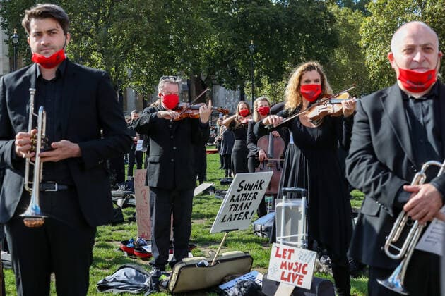 Freelance professional musicians wearing face protective masks and keeping social distance are gathered to perform a two-minute silence for the Let Music Live campaign, raising awareness of the need for targeted support for freelance musicians during the coronavirus pandemic and calling on the Government to recognise that freelance musician is an economic asset. The performance was concluded in Parliament Gardens, outside the Houses of Commons in London, on Tuesday, Oct 6, 2020. Musicians in Britain are using their voices and instruments to protest against the government instructions to retrain and lack of support to the industry. , Let Music Live Protest London Parliament Gardens England United Kingdom  , Copyright: xVudixXhymshitix