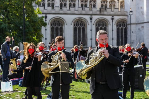 Freelance professional musicians wearing face protective masks and keeping social distance are gathered to perform a two-minute silence for the Let Music Live campaign, raising awareness of the need for targeted support for freelance musicians during the coronavirus pandemic and calling on the Government to recognise that freelance musician is an economic asset. The performance was concluded in Parliament Gardens, outside the Houses of Commons in London, on Tuesday, Oct 6, 2020. Musicians in Britain are using their voices and instruments to protest against the government instructions to retrain and lack of support to the industry. , Let Music Live Protest London Parliament Gardens England United Kingdom  , Copyright: xVudixXhymshitix