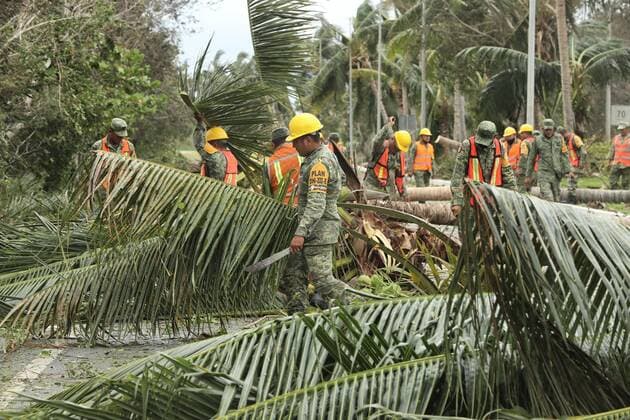 (201008) -- QUINTANA ROO, Oct. 8, 2020 -- Soldiers clean up fallen trees after Hurricane Delta hit Cancun, Quintana Roo state, Mexico, Oct. 7, 2020. Hurricane Delta weakened from a category 4 to a category 2 cyclone as it made landfall early Wednesday in the Mexican Caribbean state of Quintana Roo, but heavy rains and strong winds still caused some infrastructure damage, the National Meteorological Service (SMN) said. (Photo by Xinhua) MEXICO-QUINTANA ROO-HURRICANE DELTA MauricioxCollado 