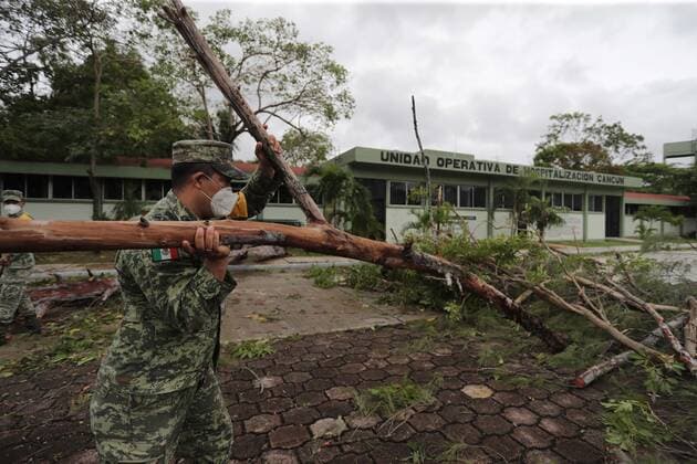 (201008) -- QUINTANA ROO, Oct. 8, 2020 -- A soldier cleans up fallen trees after Hurricane Delta hit Cancun, Quintana Roo state, Mexico, Oct. 7, 2020. Hurricane Delta weakened from a category 4 to a category 2 cyclone as it made landfall early Wednesday in the Mexican Caribbean state of Quintana Roo, but heavy rains and strong winds still caused some infrastructure damage, the National Meteorological Service (SMN) said. (Photo by Xinhua) MEXICO-QUINTANA ROO-HURRICANE DELTA RodolfoxFlores 