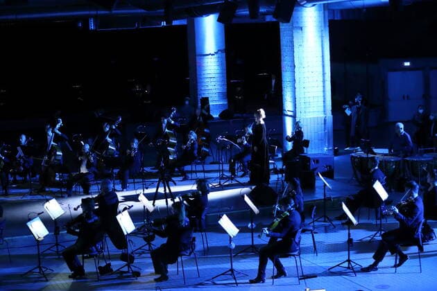 Soprano Iwona Sobotka in the middle and the Rundfunk Sinfonieorchester during the photo rehearsal for the concert installation The World To Come at Vollgutlager and SchwuZ in Berlin, 7 October 2020 A production of the Rundfunkchor Berlin After Ludwig van Beethovens Missa solemnis concept and scene Tilman Hecker Premiere is on 8 October 2020 Rundfunkch
