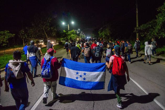 January 15, 2020, San Pedro Sula, Honduras: Migrants march with a Honduran flag walking towards the Guatemalan border at 4am on the first day of their journey to the U.S. border. .Migrants are fleeing from extreme poverty and gang violence, hoping to find a better life in the U.S. They must travel over 3,000 miles through Guatemala and Mexico, often times with nothing but the clothes on their back, to reach the border in Tijuana, Mexico where their fate is undecided. San Pedro Sula Honduras - ZUMAs197 20200115_zab_s197_039 Copyright: xSethxSidneyxBerryx