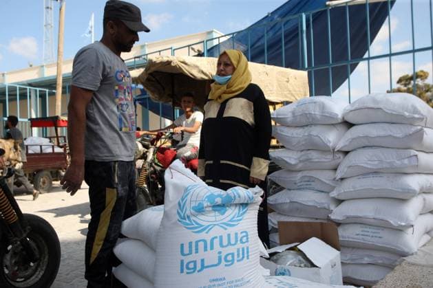 Palestinian refugees receive aid distributed by UNRWA amid the Covid-19 coronavirus disease outbreak, at the United Nations centre in Rafah, in the southern Gaza Strip,, on Wednesday on October 14 2020.  GAZ2020101406 IsmaelxMohamad