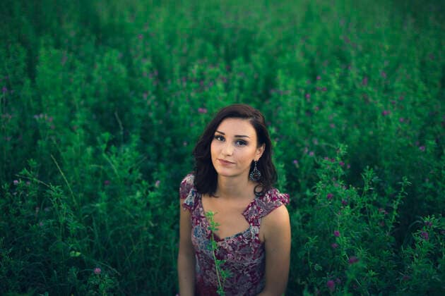 Creative Highlights Symbolfotos Portrait of a woman sitting in tall grass model released Symbolfoto LCU000012
