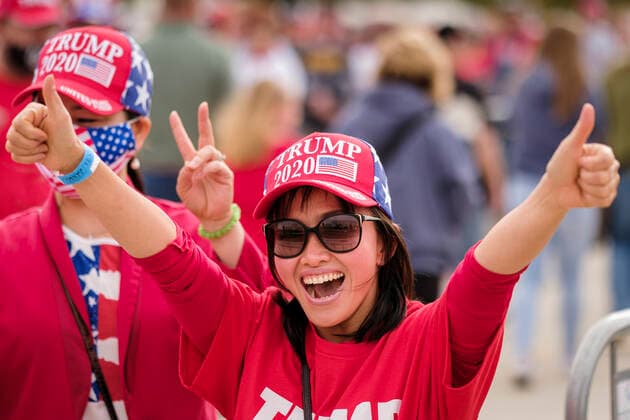 October 14, 2020, Des Moines, Iowa, U.S: A woman cheers for President Donald Trump before a Trump reelection rally in Des Moines. About10,000 people were expected at the Des Moines International Airport for a campaign rally supporting the reelection of President Donald Trump. Trump spoke at the rally, despite testing positive for COVID-19 less than three weeks ago. The rally did not meet the CDC guidelines for a safe gathering in the time of Coronavirus and violated Iowa s health emergency declarations barring gatherings of more than 25 people. This week Iowa exceeded 101,000 cases of COVID-19 and a surge in hospitalizations for COVID-19. Des Moines U.S. - ZUMAk94_ 20201014_zaf_k94_035 Copyright: xJackxKurtzx