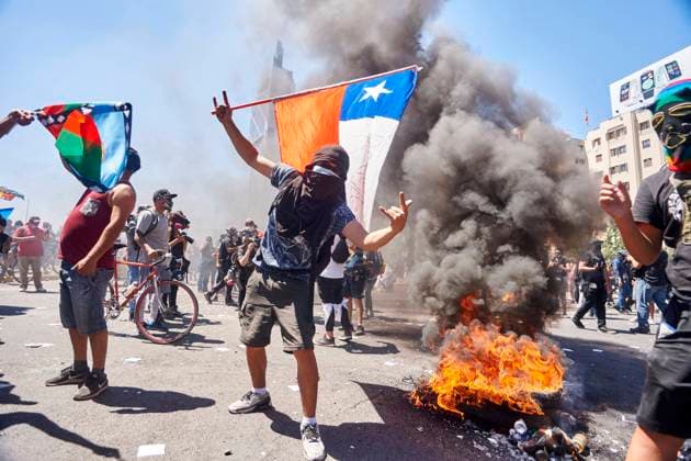 October 18, 2020, Santiago, Chile: Protesters mark the anniversary of the outbreak of rioting and social unrest in 2019. The milestone comes a week before a referendum on October 25 in which polls predict about two-thirds of Chileans will vote in favor of drawing up a new constitution - one of the central demands of protesters angered by issues such as rising prices, inequality, meagre pensions and poor public services. Many expect a second wave of protests, with unrest already intensifying over the past week. Santiago Chile - ZUMA Pho 20201018_mda_a202_086 Copyright: xFranciscoxAriasx