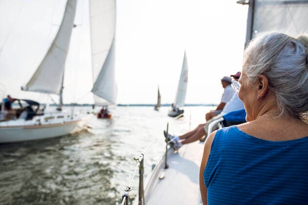 Middle aged Woman enjoying summer sail race during golden hour North Kingstown, RI, United States CR_CABR201016-515014-01 ,model released, Symbolfoto