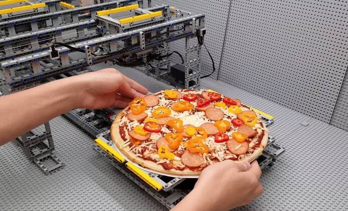 A Lego fan has built a jaw-dropping pizza-making machine entirely from Lego. Canada-based Iouri Petoukhov works with his son Michael to make amazing creations under the name The Brick Wall. Now they have celebrated five years of their projects with an intricate machine that serves up perfect pizzas. It includes mechanisms that dispense tomato sauce, grated cheese, sausage and peppers all while the pizza base revolves to allow even covering of toppings. Iouro tells Cover Images: We have family time when all speak out about what we called crazy ideas and then we write them down on paper and put it on our Brick wall. Making Pizza is an art and love, making Pizza wit Copyright: xx 40952520 EDITORIAL USE ONLY. NOT FOR USE BY NEWSPAPERS BASED IN THE UK.