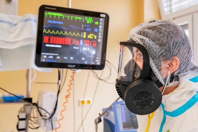 Doctor Kristina Sukova with protective clothing cares for a patient in the intensive care unit (ICU) for patients with COVID-19 disease in the Pribram Regional Hospital, Czech Republic, on October 23, 2020. (CTKxPhoto MiroslavxChaloupka) CTKPhotoP202010230557801 cha0014