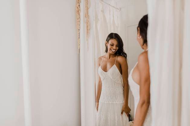 Smiling bride looking in mirror while standing at home model released Symbolfoto property released SMSF00312