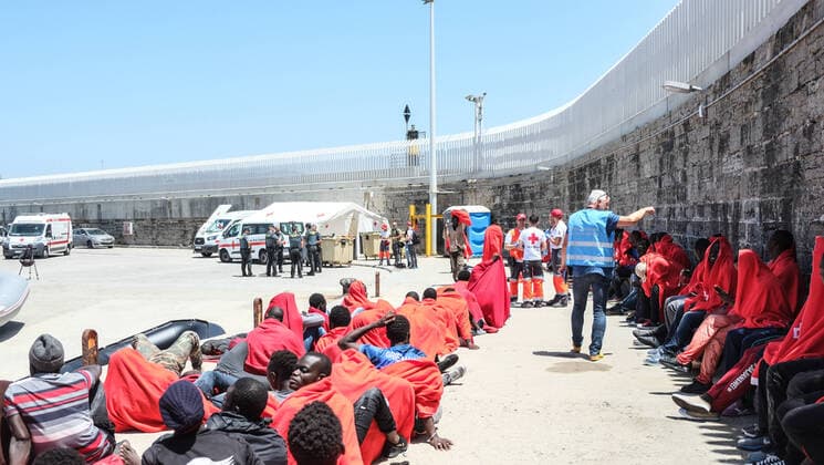 Migrants and refugees rescued from the Mediterranean are sitting and standing in the port of Tarifa, Spain on 24 July 2018 Hundreds of boat refugees from Morocco will arrive daily in the summer of 2018 to the European Union Tarifa Spain
