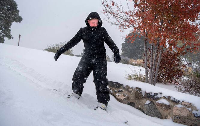 October 26, 2020, USA: Joseph Harkey, 15, tries out a snowboard on a snow covered hill at Ashley Pond in Los Alamos Monday October 26, 2020. A winter storm dumped several inches of snow in the area. USA - ZUMAab1_ 20201026_zaf_ab1_005 Copyright: xEddiexMoorex