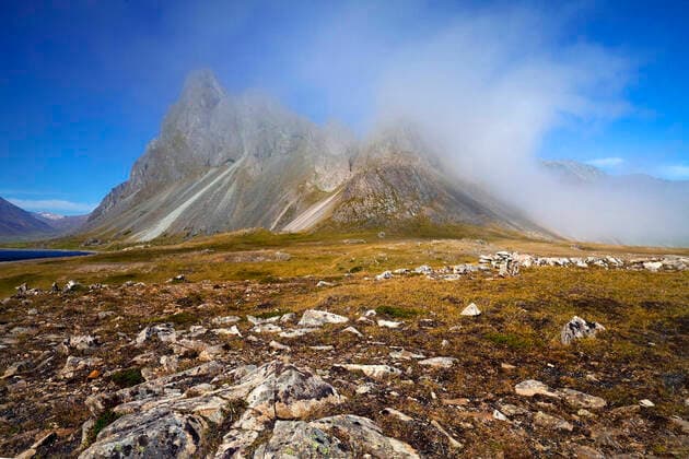 Panoramic view of mountain Eystrahorn with blue sky and single cloud, weather divide, Iceland, East Iceland, Eystrahorn vista onto mountain Eystrahorn with blue sky and single cloud, weather divide, Iceland, East Iceland, Eystrahorn BLWS631267 Copyright: xblickwinkel S.xZiesex