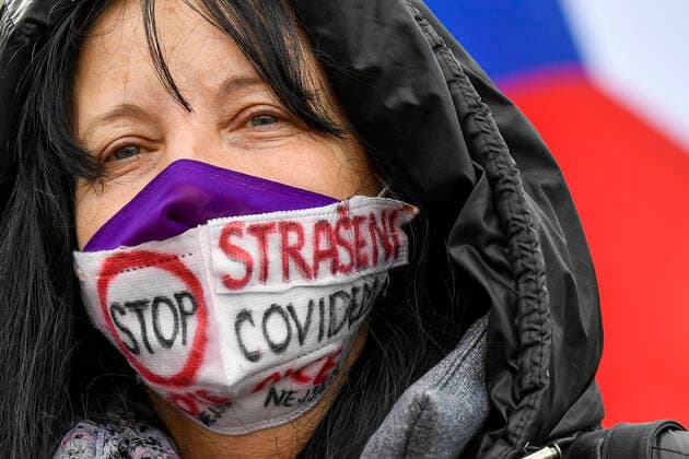 Woman protests against government lockdown measures at the Old Town square in the Prague centre, Czech Republic, October 28, 2020. Under the government decree of October 22, maximally 100 people can attend a peaceful rally, in the groups of 20. The demonstrators must keep distance among the groups and all of them must wear face masks. (CTKxPhoto VitxSimanek) CTKPhotoP202010280656001  VIS 002 K