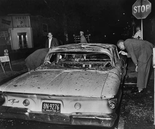 July 29, 2020, Brooklyn, New York, USA: Detective examining burned out Police Car after night of rioting due to fatal shooting of Teen James Powell by Police Officer Lt. Thomas Gilligan, Herkimer Street and Nostrand Avenue, Brooklyn, New York, USA, Stanley Wolfson, World Telegram & Sun, July 1964 Brooklyn USA - ZUMAg145 20200729_zza_g145_010 Copyright: xJTxVintagex