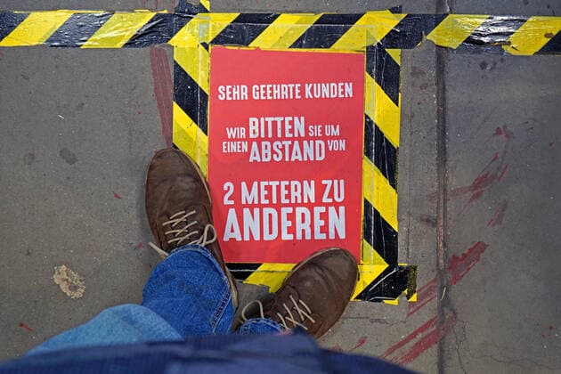 Restrictions due to the coronavirus As a measure to prevent infection with the coronavirus, customers in a DIY store are advised to observe the distance regulation on floors Essen Nordrhein Westfalen Germany