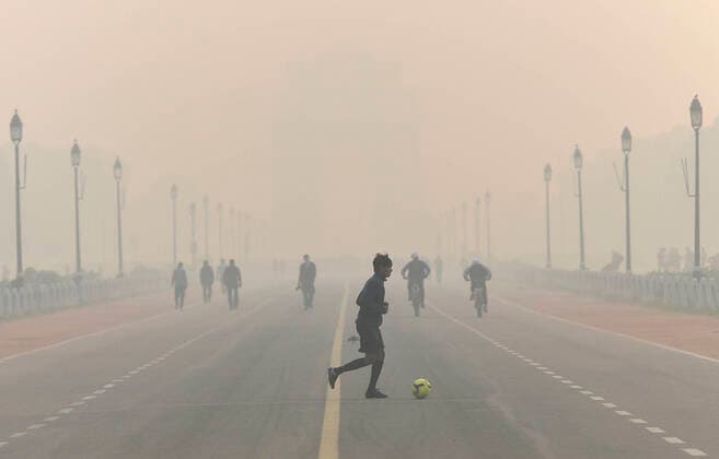 IMAGO Nature: Unsere Erde, Umweltverträgliche Herausforderungen, Kohlendioxid NEW DELHI, INDIA - NOVEMBER 7: A youngster plays football at India Gate amid dense smog, on November 7, 2020 in New Delhi, India. (Photo by Biplov Bhuyan Hindustan Times) Pollution On Rise In Delhi-NCR