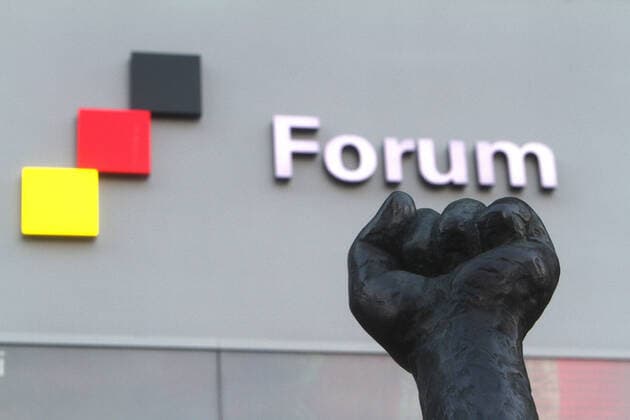 The fist of a sculpture with the flag of the Federal Republic of Germany and the inscription Forum in front of the entrance to the Forum of Contemporary History in Leipzig, Saxony, Germany