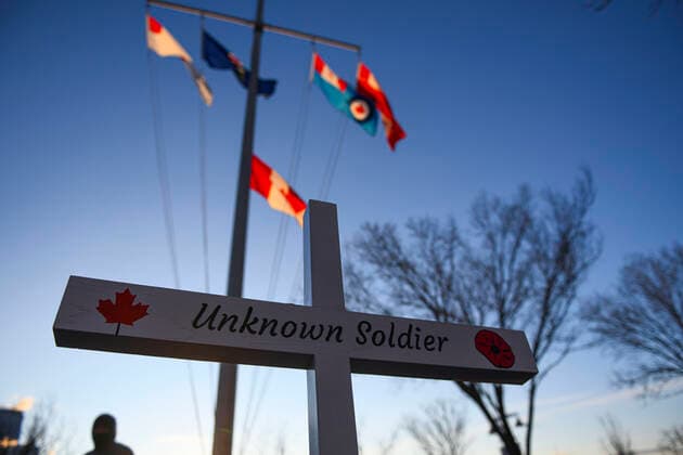 November 11, 2020, Calgary, Alberta, Canada: A cross representing the Unknown Solider stands in front of the Canadian flags on Remembrance Day, November 11th, at the Field of Crosses memorial in Calgary, Alberta. The Field of Crosses is a yearly memorial that recognizes the nearly 120,000 Canadian veterans who lost their lives in wars since 1914. Calgary Canada - ZUMAj113 20201111_zip_j113_004 Copyright: xGavinxJohnx