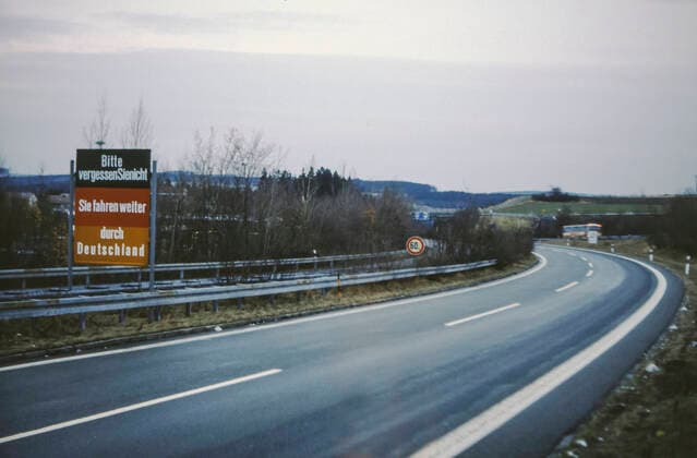 sign PLEASE DO NOT FORGET YOU RIDING THROUGH GERMANY before the border crossing Rudolphstein Hirschberg, one of the few border crossings passable for motor vehicles, Inner German border GDR German Democratic Republic FRG Federal Republic of Germany, on the Autobahn 9 between Rudolphstein Upper Franconia Bavaria and Hirschberg District Gera, today Thu