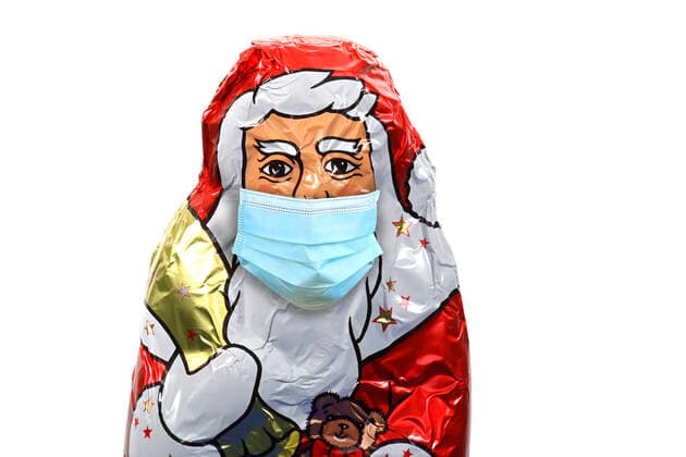 Symbolic image Christmas during the Corona crisis, a chocolate Santa Claus with mouthguard, Stuttgart, Baden Württemberg, Germany Refrigerator filled to bursting