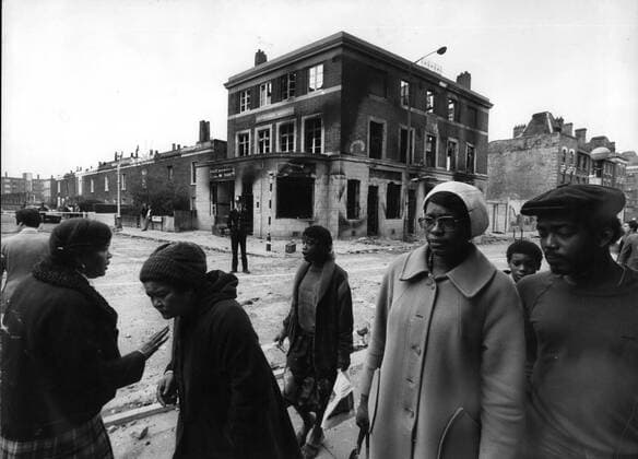 April 4, 1981, Brixton, England : Residents picking their way through the debris strewn street. The remains of a public house is a reminder of the violence. Looting spread through the the streets of Brixton, in south London last night, for the second successive night running, with police using their riot shields to charge the marauding gangs of youths. Some white others black youth gangs. Police buses and vans were attacked and shops and cars. By late last night 201 policemen and two police women had been injured and 215 people arrested since the weekend trouble flared up on Saturday. Brixton United Kingdom - ZUMAk09_ 19810404_baf_k09_053 Copyright: xKeystonexPressxAgencyx