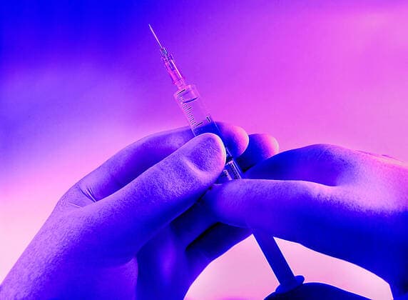 Two hands holding a syringe McPBBO McPBBO