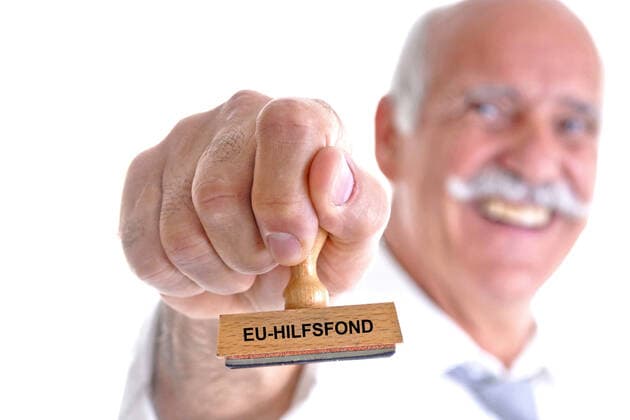 old man holding a stamp in his hand with the inscription EU aid fund, Germany old man with stamp in his hand lettering EU aid fund EU aid fund, Germany BLWS633737 Copyright: xblickwinkel McPHOTO B.xLeitnerx