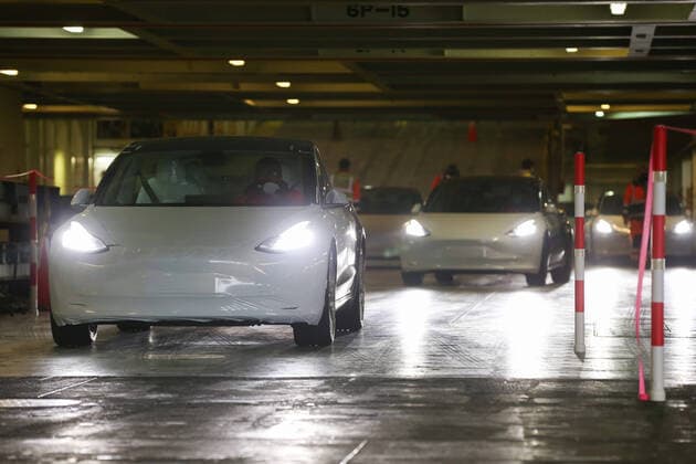 (201128) -- BRUSSELS, Nov. 28, 2020 -- Staff members drive Tesla Model 3 vehicles out of a vessel at Zeebrugge port, Belgium, Nov. 27, 2020. TO GO WITH XINHUA HEADLINES OF NOV. 28, 2020 ) BELGIUM-CHINA-MADE TESLA-ARRIVAL ZhengxHuansong 