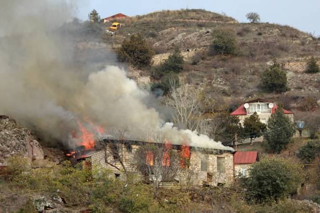 NAGORNO-KARABAKH - NOVEMBER 30, 2020: A house is set on fire in the town of Lachin (Berdzor). According to the trilateral agreement on a complete ceasefire signed by the leaders of Armenia, Russia, and Azerbaijan on 9 November, Armenia hands over Nagorno-Karabakh s Lachin District to Azerbaijan on 1 December. Russian outposts are established along the contact line in Nagorno-Karabakh and the Lachin Corridor mountain pass. Alexander Ryumin TASS  TS0F0100