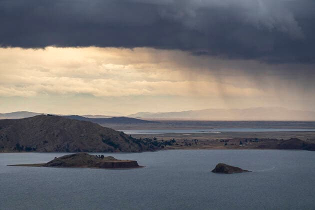 Dramatic sky over coast of Lake Titicaca at Capachica, Peru Puno, Puno, Peru CR_FHNX201130A-532847-01