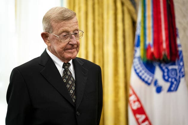 Former college football coach Lou Holtz stands before President Trump presented him with a Medal of Freedom, in the Oval Office at the White House in Washington, DC on Thursday, December 3, 2020. Holtz, the hall of fame college football coach, had a 34 year coaching career that included winning the 1988 national championship with the University of Notre Dame. Holtz coached six different programs to bowl games and four different teams to top 20 final rankings. Pool photo by Doug Mills  WAX20201203342 DOUGxMILLS