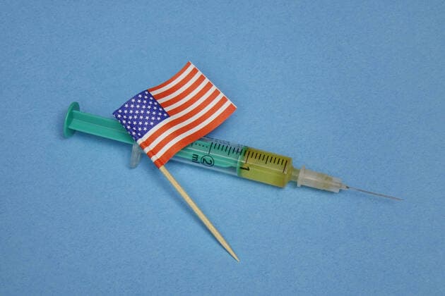 Syringe and flag Syringe and flag, 05 12 2020, Borkwalde, Brandenburg, Germany, On a syringe lies a flag from the USA