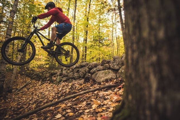 Male mountain biker going off jump during foliage season Conway, NH, United States CR_BRDO201207B-579936-01 ,model released, Symbolfoto