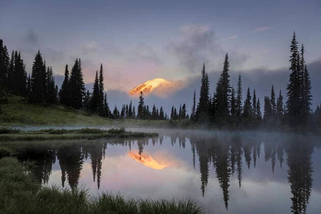 Creative Highlights World Mount Rainier peeking through the clouds during early morning sunrise Olympia, WA, United States CR_NAFL201204A-579874-01