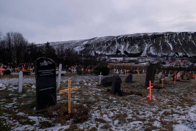 Graves at Lágafellskirkju cemetery near Mosfellsbær illuminated with electric grave crosses in bright colours The graves are decorated at Christmas time to bring light to the ancestors in the dark season Traditionally, the graves of the deceased are also visited during the Christmas holidays Illuminated cemetery