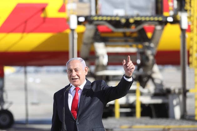 (201209) -- TEL AVIV, Dec. 9, 2020 -- Israeli Prime Minister Benjamin Netanyahu attends a ceremony to mark the arrival of a plane of the international courier company DHL carrying the first batch of Pfizer coronavirus vaccines which lands at Ben Gurion International Airport near central Israeli city of Tel Aviv amid the COVID-19 pandemic on Dec. 9, 2020. An initial shipment of COVID-19 vaccines from Pfizer arrived in Israel on Wednesday morning, the first of about 8 million Pfizer vaccines that the country is expected to receive. A DHL cargo flight from Belgium s Brussels landed at the Ben Gurion airport outside Tel Aviv, carrying a small number of vaccines for a pilot run of the logistic of transportation and refrigerated storage proc 