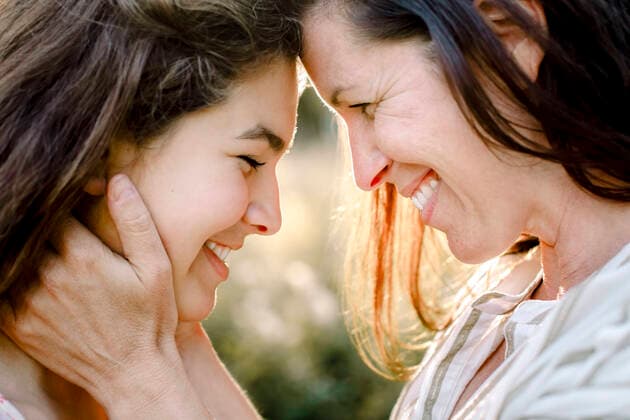 Smiling mother embracing daughter in yard, MA82755, Sweden, Stockholm Archipelago, model released Copyright: xMaskotx